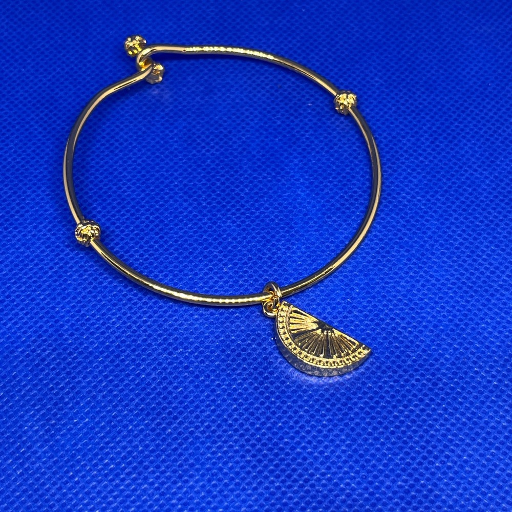Signed Lilly Pulitzer gold tone bangle with citrus charm. Very good condition